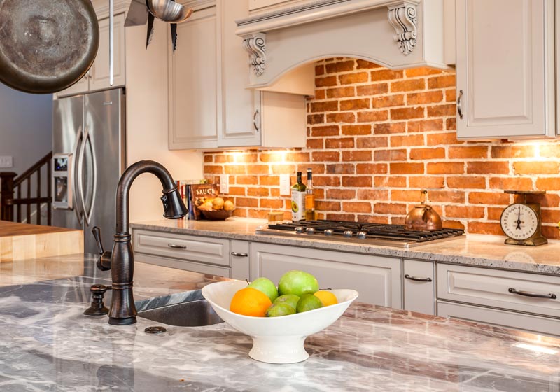 Brick wall behind stove in this Genessee Colorado kitchen Renovation project