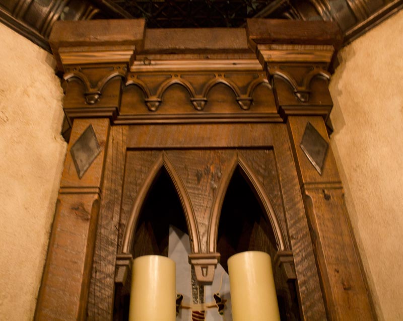 This open cabinet shows arched doors in pecan stain