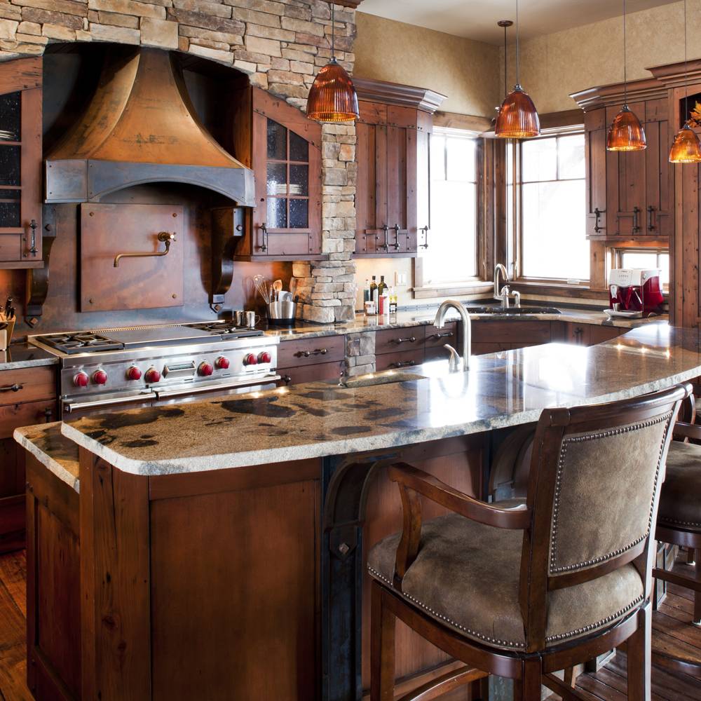 Homestead cabinet kitchen with dramatic stove hood, two level countertops with eating space