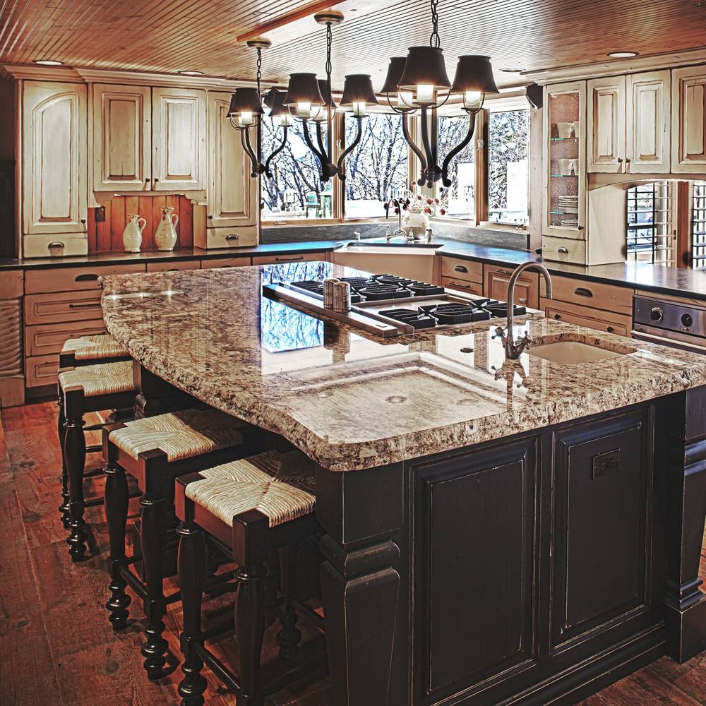 Homestead cabinets Colorado Rustic Kitchen Design with black and white distressed painted wood, center island stove and sink.