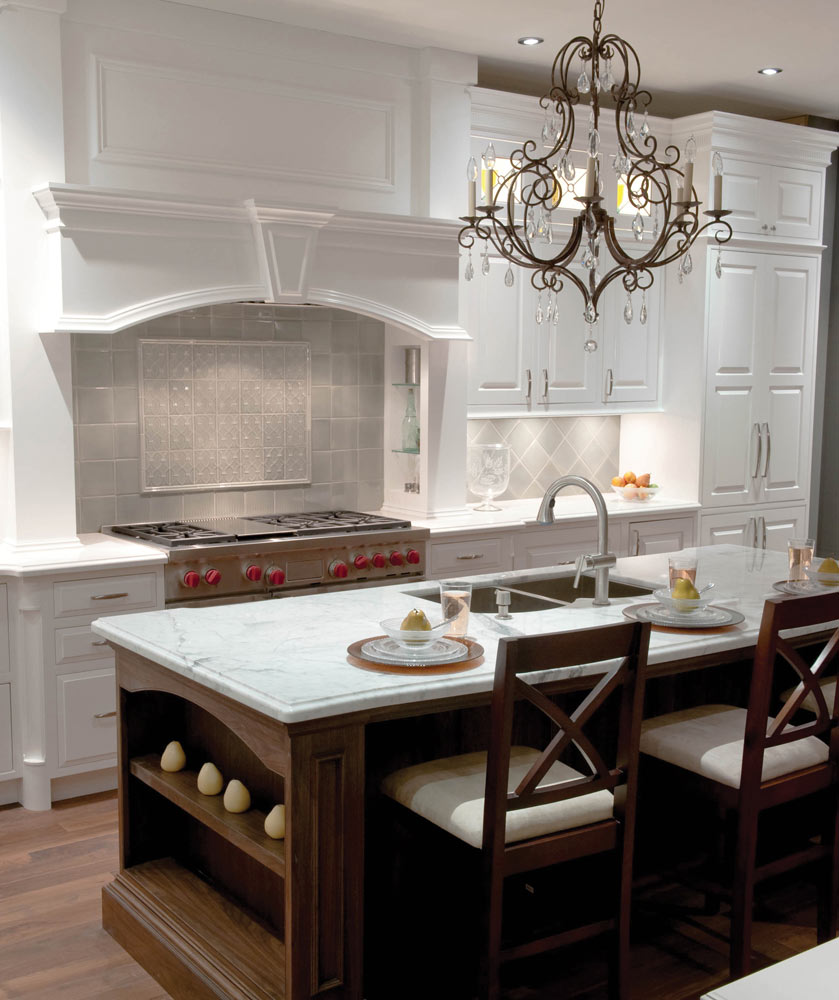 white painted wood kitchen with crystal stove hood