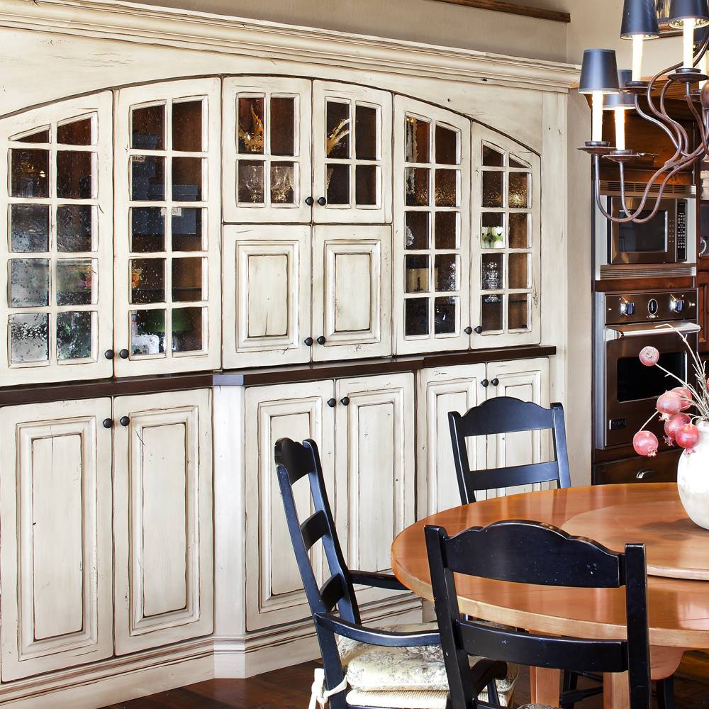 Full Custom Kitchen with Distressed Painted Wood Cabinets with Glass Front Doors.