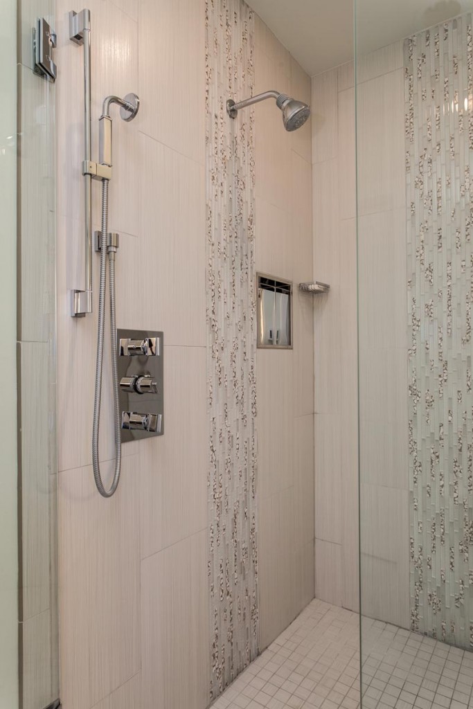 huge master shower with double heads and custom tile