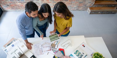 two women and a man review samples to ensure their remodel is exactly what they want JM Kitchen & Bath Design