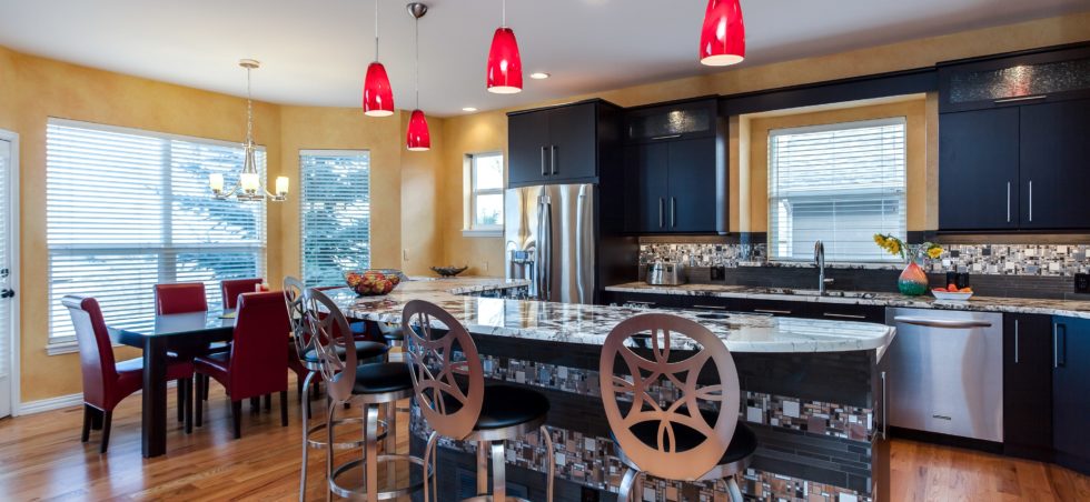 Black cabinet kitchen with unique tile backsplash