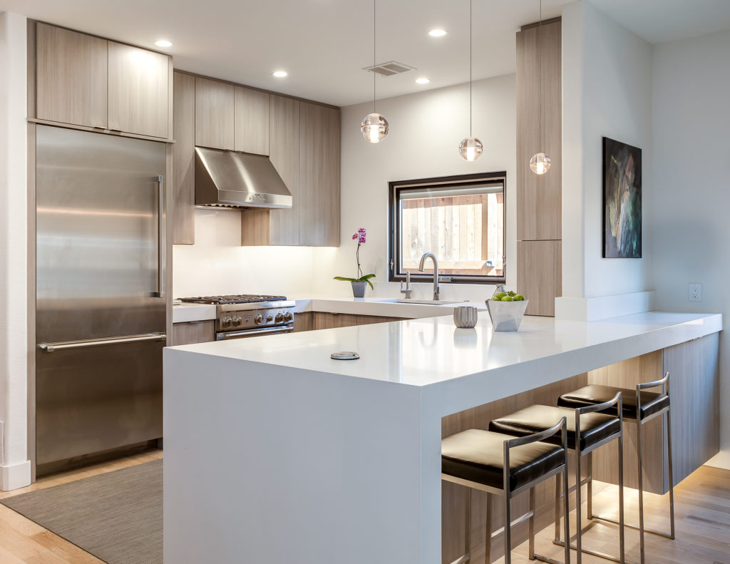 Contemporary kitchen with stainless steel fridge and stove