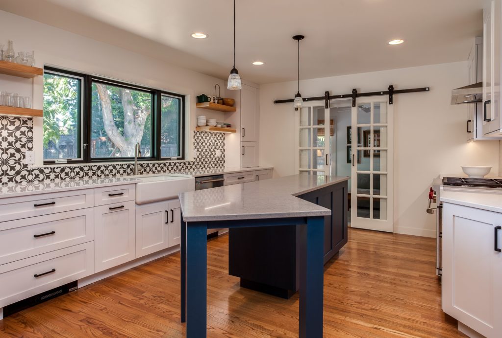 White kitchen cabinets with large vessel sink