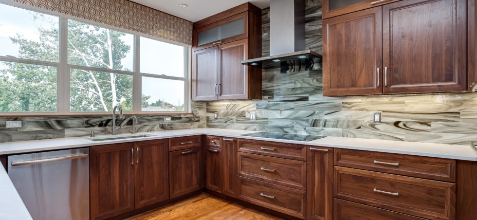 Dark wood cabinets with unique marble backsplash