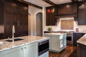 Dark wood cabinets with beautiful tile backsplash JM Kitchen & Bath Design