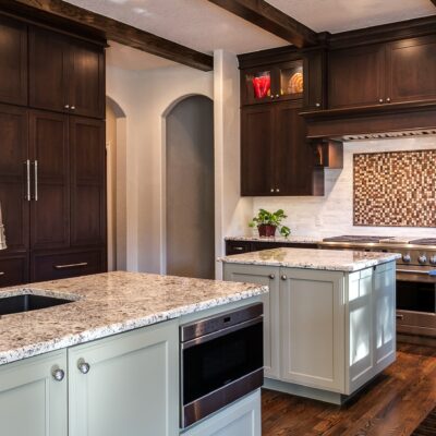 Dark wood cabinets with beautiful tile backsplash JM Kitchen & Bath Design