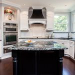 White cabinet kitchen with dark granite countertop