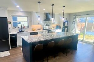 full view of kitchen remodel with large island and accent lights JM Kitchen & Bath Design