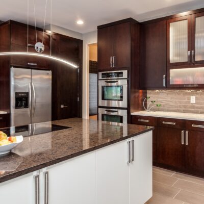 Dark wood minimal cabinets with large center island JM Kitchen & Bath Design