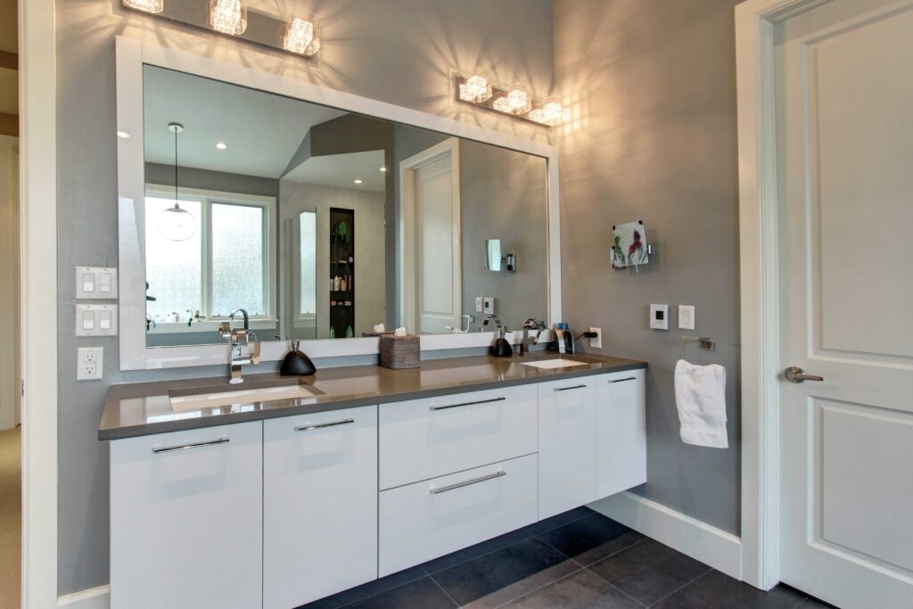 bathroom updates include floating vanity and large mirror JM Kitchen & Bath Design