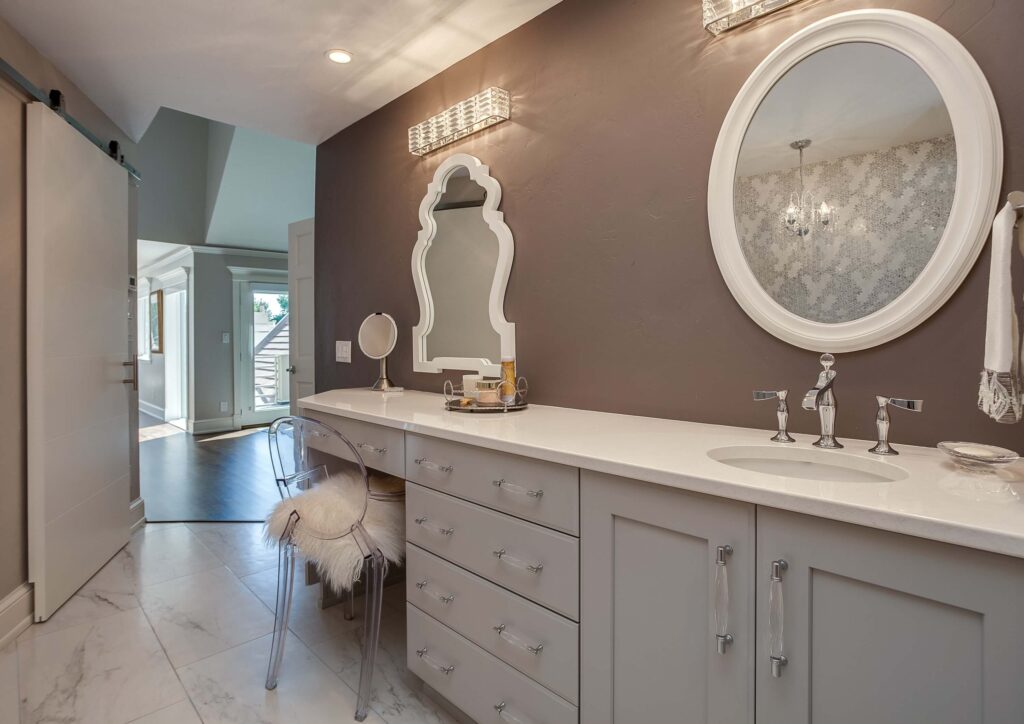 new bathroom with white finishes including cabinets, vanity, and two mirrors with white frames JM Kitchen & Bath Design