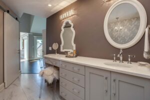 new bathroom with white finishes including cabinets, vanity, and two mirrors with white frames JM Kitchen & Bath Design