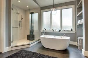 light and bright is the focus of this bathroom remodel with large white tub and walk-in shower JM Kitchen & Bath Design