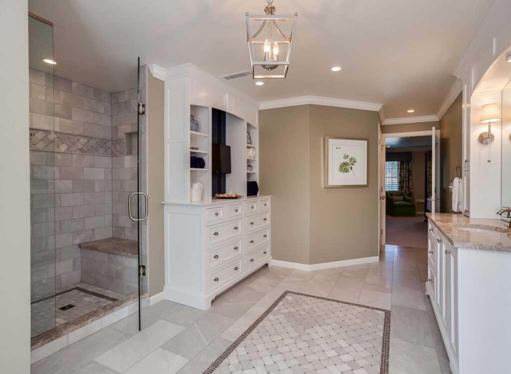 large walk-in shower with bench and plenty of storage space are features in this bathroom remodel from JM Kitchen & Bath Design