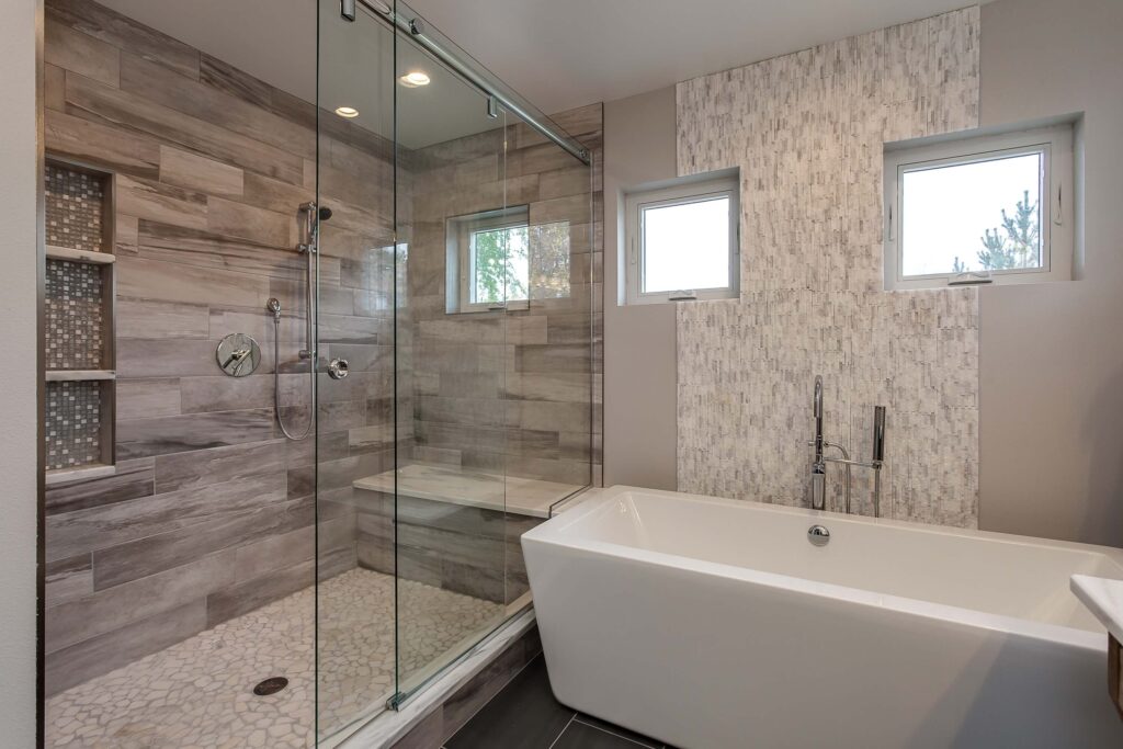 bathroom remodel features large rectangle free standing tub and large shower with sliding glass door JM Kitchen & Bath Design