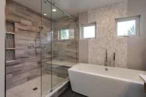 bathroom remodel features large rectangle free standing tub and large shower with sliding glass door JM Kitchen & Bath Design