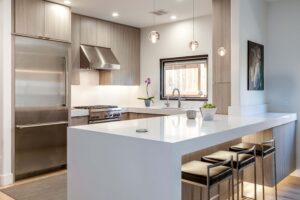 ultra modern kitchen design featuring lighting under countertop and corner edge finish JM Kitchen & Bath Design