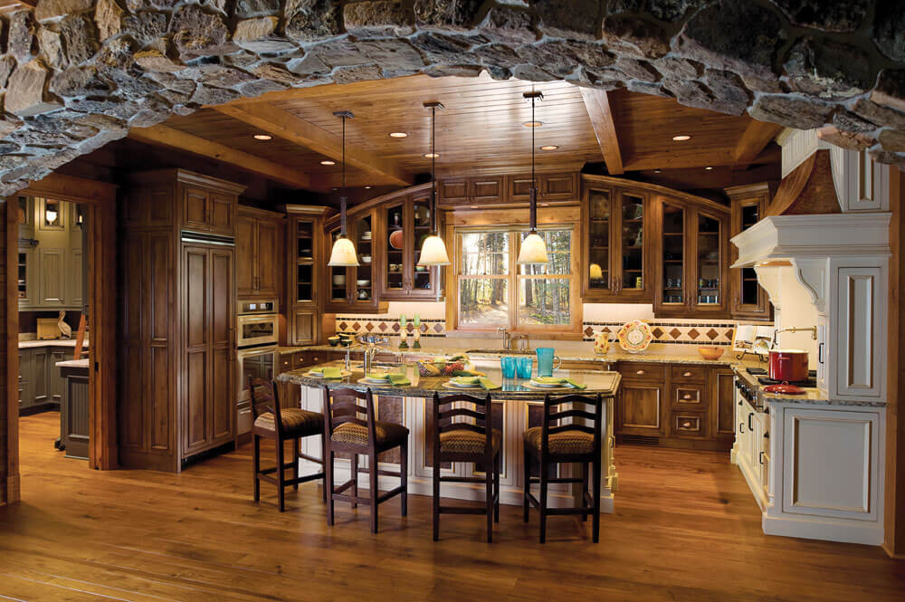 full view of remodeled kitchen featuring custom arched cabinets and island with seating area JM Kitchen & Bath Design