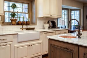 remodeled kitchen with apron sink, island and new windows JM Kitchen & Bath Design