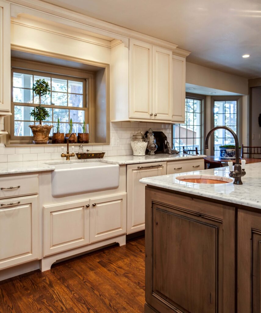 remodeled kitchen with apron sink, island and new windows JM Kitchen & Bath Design