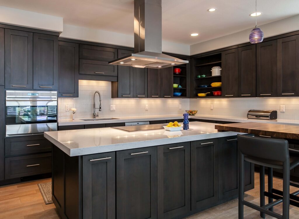 modern kitchen remodel from JM Kitchen & Bath Design features 90 degree angel countertops, island, and seating area