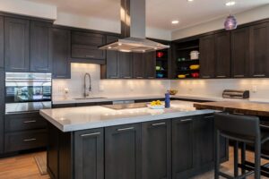 modern kitchen remodel from JM Kitchen & Bath Design features 90 degree angel countertops, island, and seating area