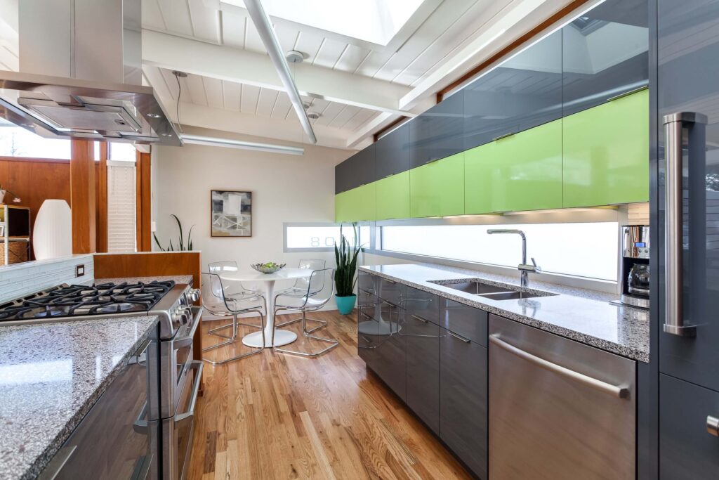 mid century modern kitchen featuring dark gray finishes with green cabinets and skylight JM Kitchen & Bath Design