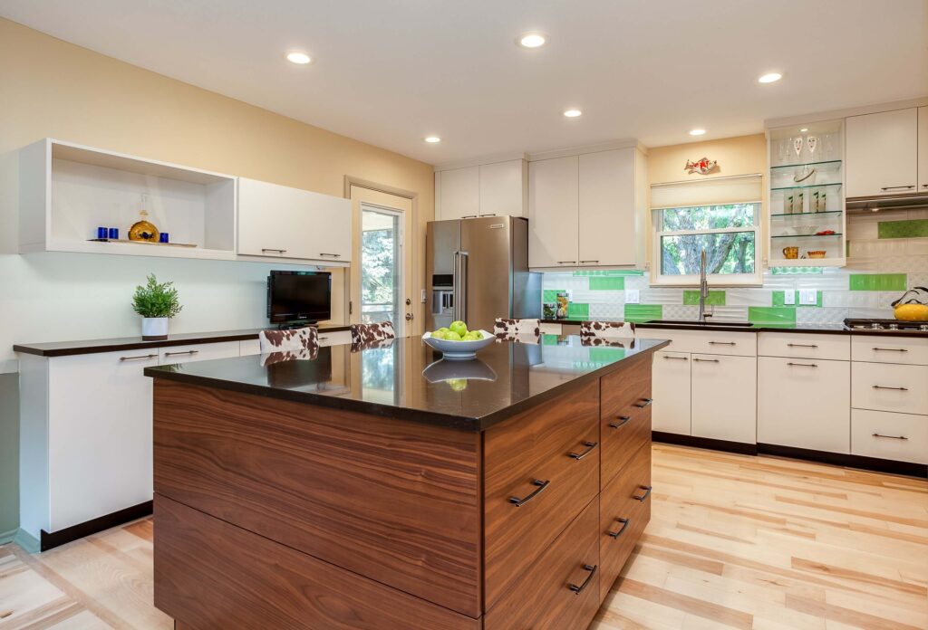 unique kitchen remodel with green and white tile and large island with storage JM Kitchen & Bath Design