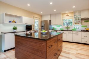 unique kitchen remodel with green and white tile and large island with storage JM Kitchen & Bath Design