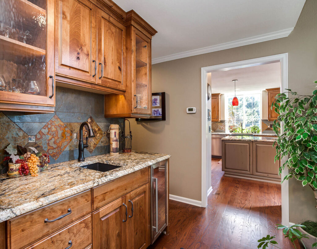 remodeled bar with granite countertop and unique copper tile accent JM Kitchen & Bath Design