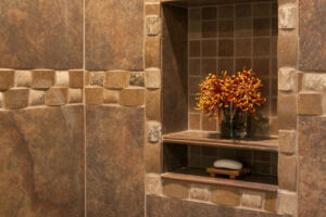 close up of tile cove in shower for soap, shampoo, and other essentials in remodeled bathroom JM Kitchen & Bath Design