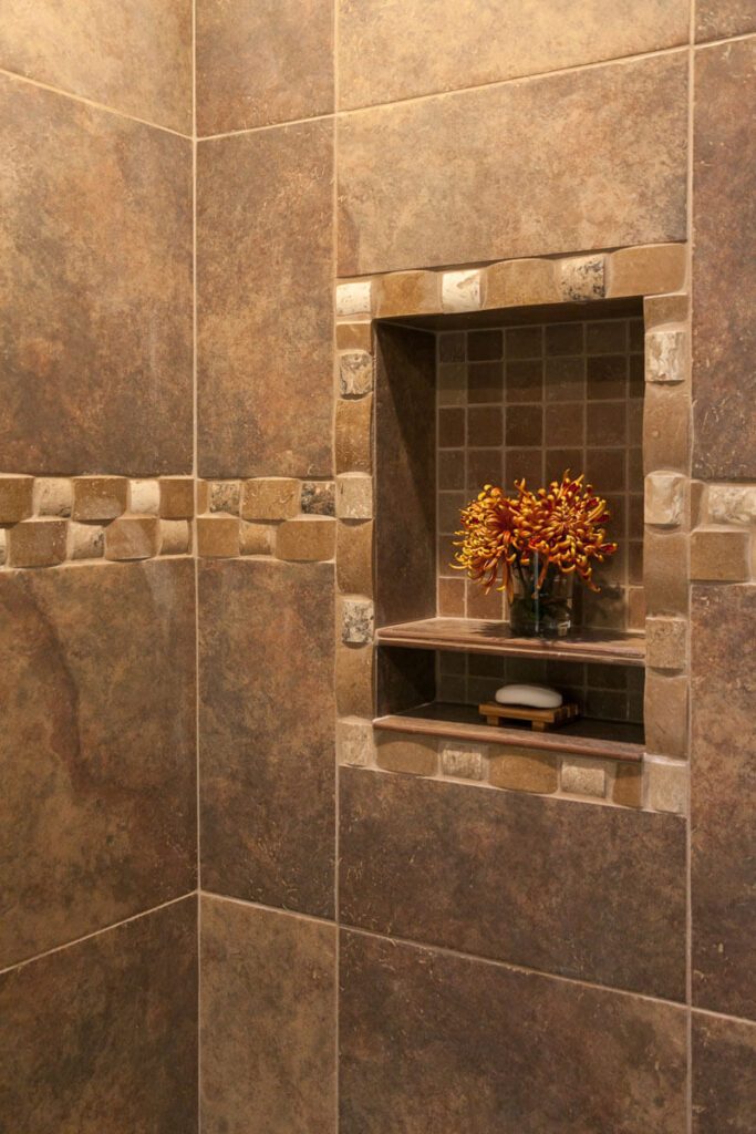 close up of tile cove in shower for soap, shampoo, and other essentials in remodeled bathroom JM Kitchen & Bath Design