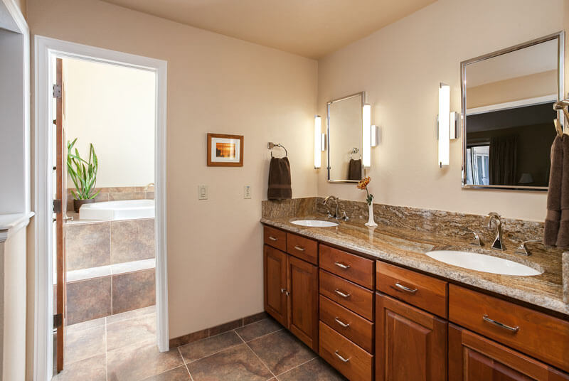 large tile and granite double vanity compliment each other in bathroom remodel JM Kitchen & Bath Design