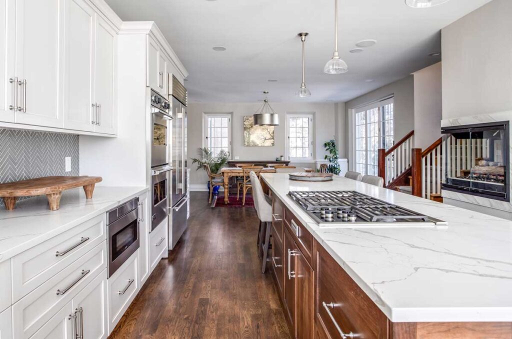 remodeled kitchen features large island with seating area JM Kitchen & Bath Design