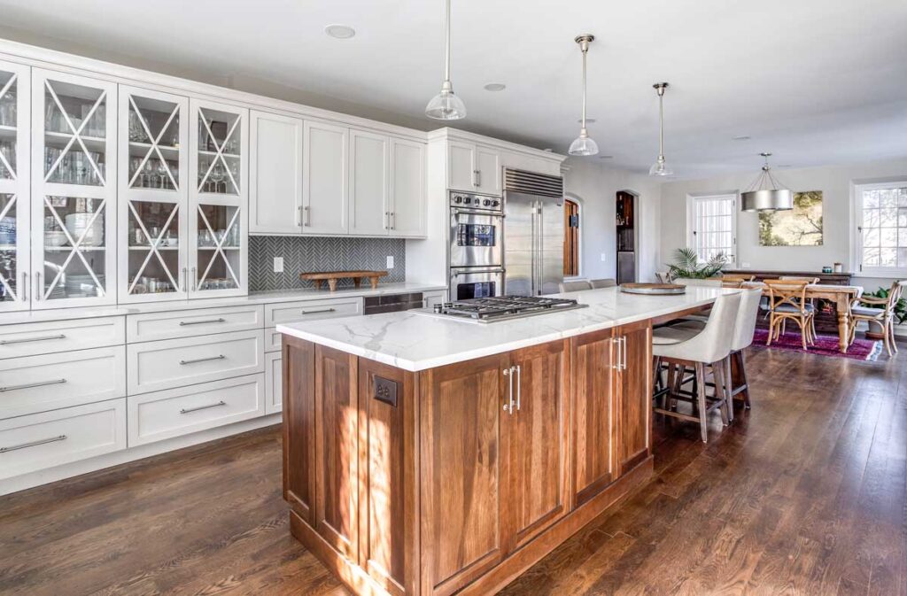 large white cabinets with glass display are featured in kitchen remodel JM Kitchen & Bath Design