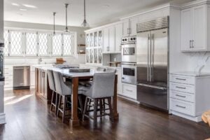 cabinet space and windows are featured in white kitchen remodel JM Kitchen & Bath Design