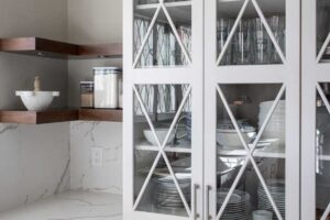 close up of corner shelving and white display cabinets with glass JM Kitchen & Bath Design