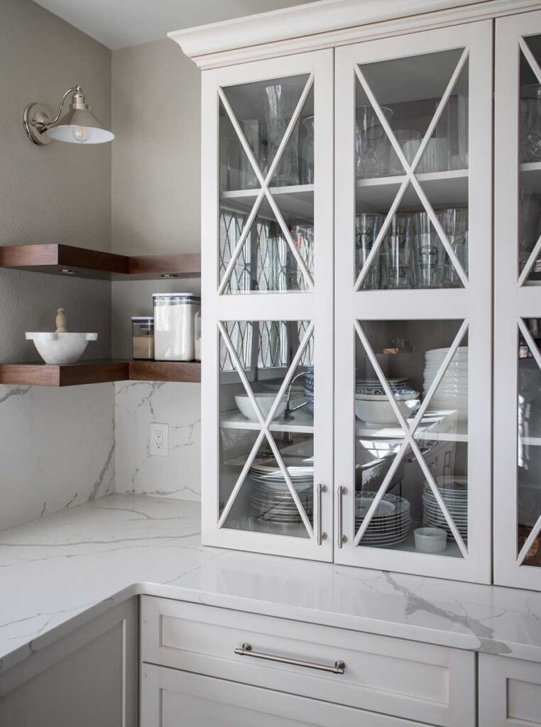 close up of corner shelving and white display cabinets with glass JM Kitchen & Bath Design