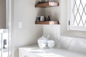 wood shelves in corner of remodeled light gray and white kitchen JM Kitchen & Bath Design