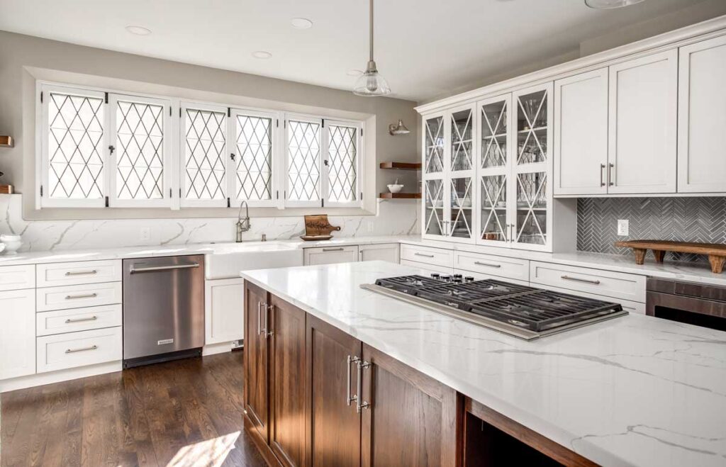 off white cabinets and gray tile accent featured in kitchen remodel JM Kitchen & Bath Design