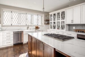 off white cabinets and gray tile accent featured in kitchen remodel JM Kitchen & Bath Design