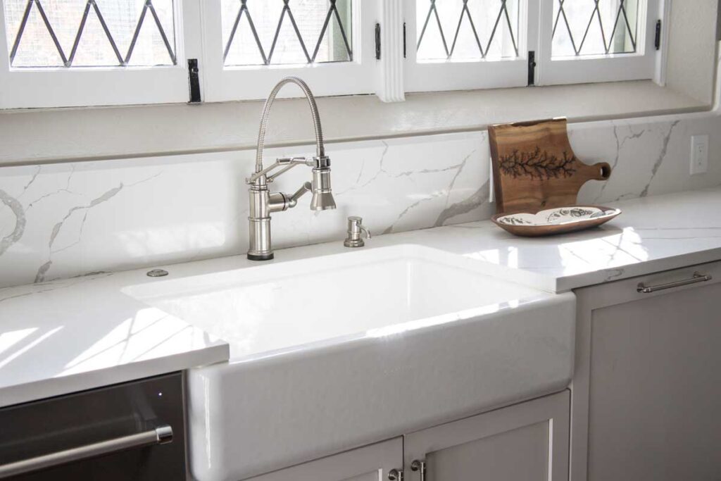 farm sink and natural light are features in kitchen remodel JM Kitchen & Bath Design