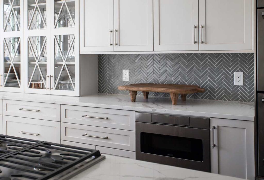 gray herringbone tile is featured in kitchen remodel JM Kitchen & Bath Design