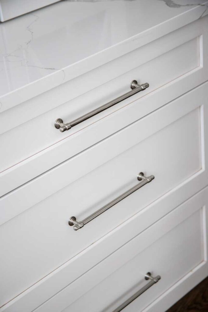 close up of hardware on white drawers in remodeled kitchen JM Kitchen & Bath Design