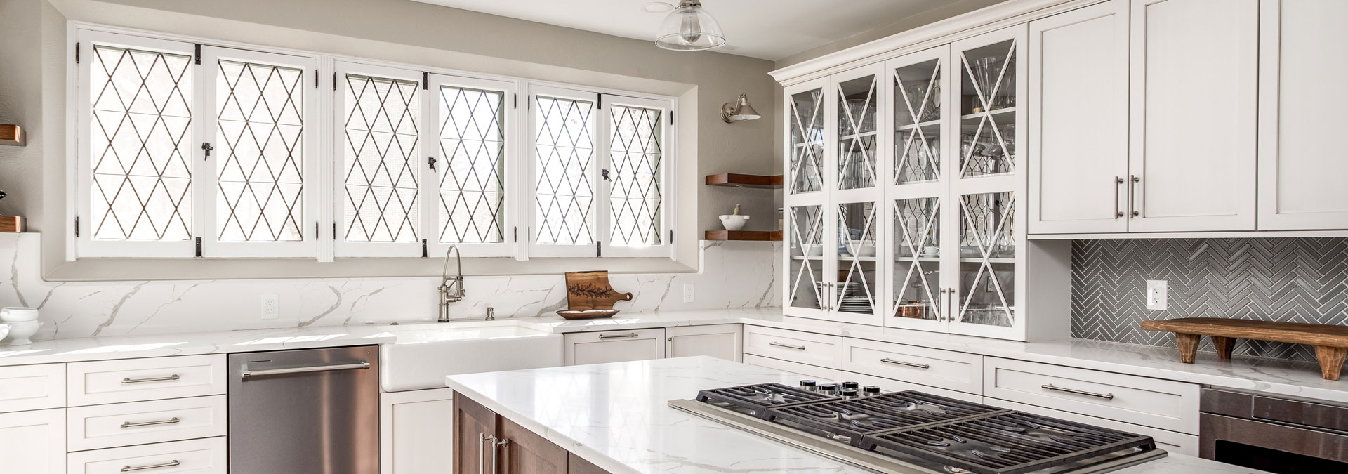 updated kitchen with white finishes and large island JM Kitchen & Bath Design