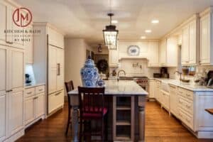 full view of country kitchen remodel with large island, custom distressed cabinets and copper finishes JM Kitchen & Bath Design